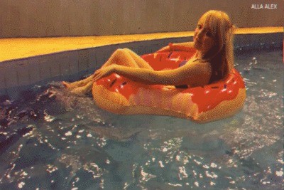 Alla floats on an inflatable ring donut in the pool.