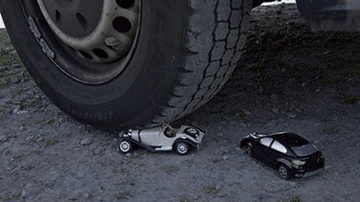 2 little cars under my giant tires