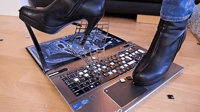 Crushing the slave's laptop under my ass and heels