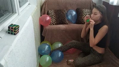 Girl blows up four balloons in a row