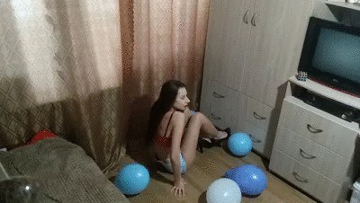 Long-haired brunette blows up balloons using heels and ass.