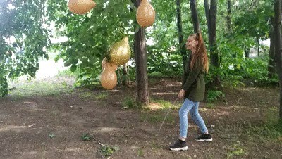 Girl with a stick explodes balloons