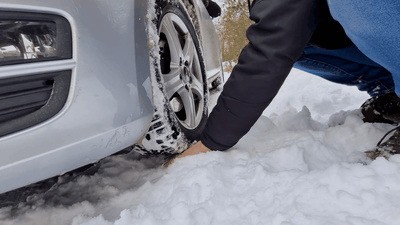 Driving over his hands in the snow