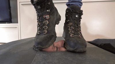 Slave's face suffers under dirty hiking boots