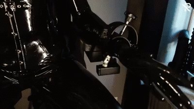 Rubberslut with Heavy Rubber Helmet fucking her pussy on slave chair