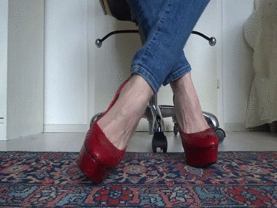 Red platform designer high heels with extreme metal heels in close-ups