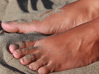 Cassandra's feet play with the sand