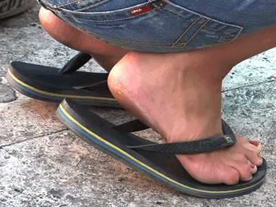 Candid tourist feet in flip flops